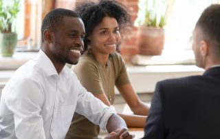 A couple talking to a financial planner.