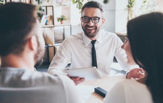 A couple in a meeting with a financial adviser.