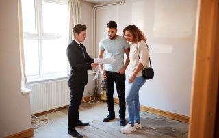A couple viewing a property with an estate agent.