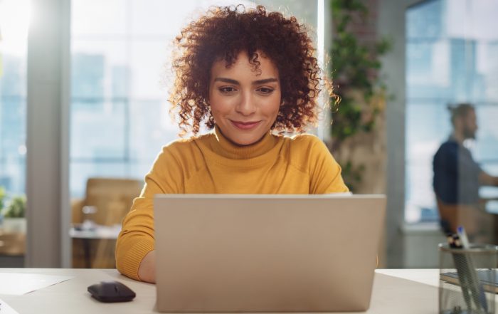 A woman using a laptop.