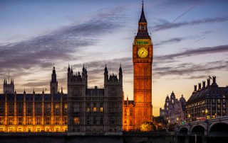 An external image of the Palace of Westminster in the evening