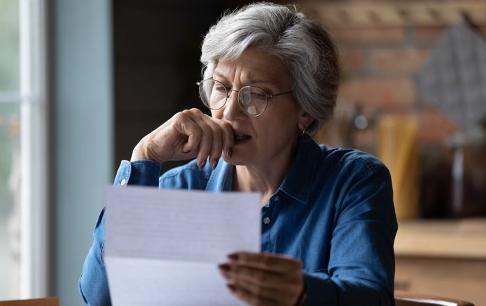 A woman reading a letter.