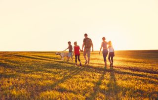 A family walking in the countryside.