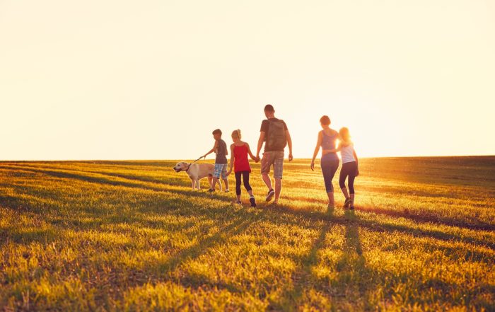 A family walking in the countryside.