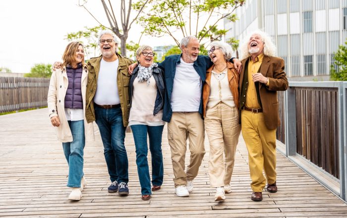 A group of people walking together and laughing.