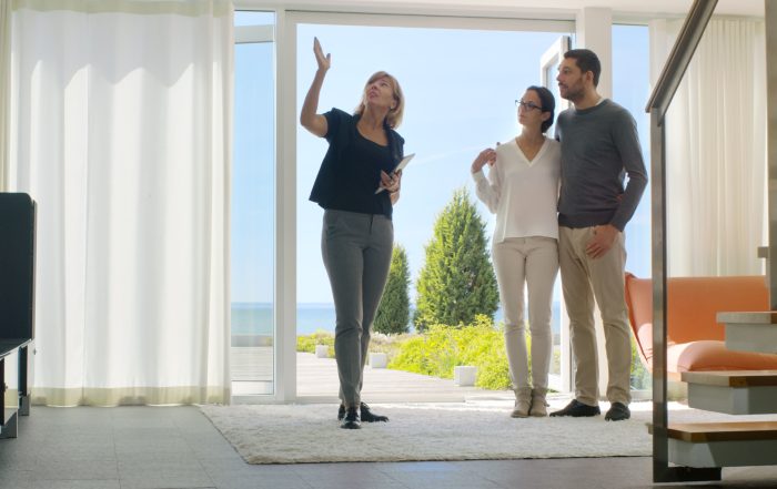 An estate agent showing a couple around a property.