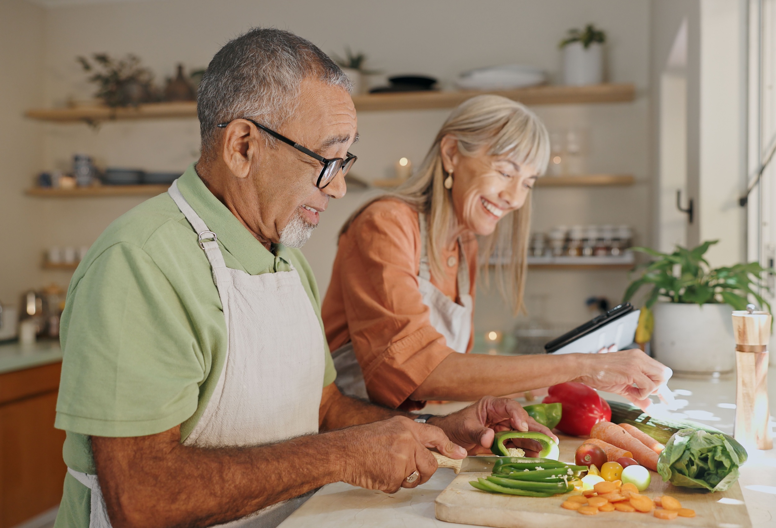 A couple cooking a meal together.