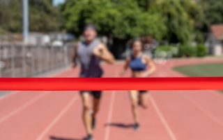 Runners running towards a finish line.