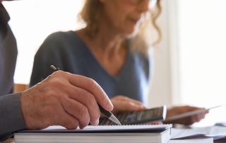 Couple looking at paperwork and using a calculator
