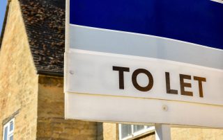 A “to let” sign outside of a home.