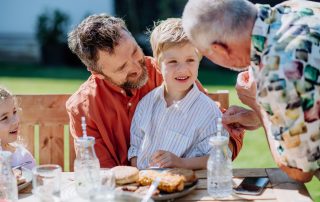A multi-generational family enjoying a picnic.