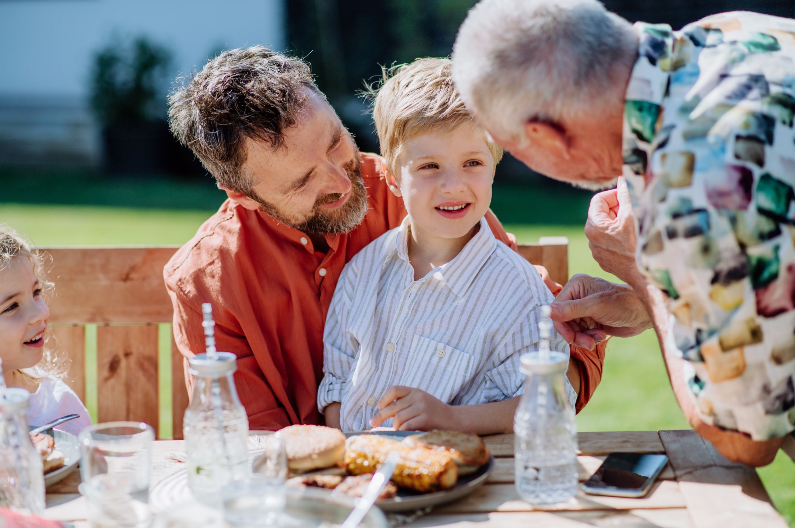 A multi-generational family enjoying a picnic.
